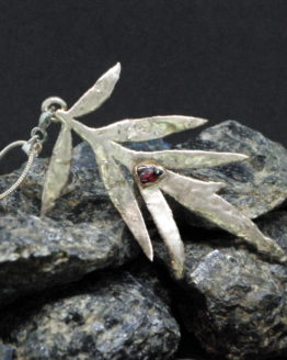 silver plated spikey leaf pendant with red garnet